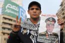 A supporter of Egypt's army chief and defense minister Sisi holds a poster during a protest in Cairo