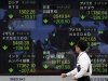A man looks at an electronic stock board of a securities firm in Tokyo Thursday, Nov. 10, 2011 as the benchmark Nikkei 225 index fell 205.50 points, to end the morning session at 8,549.94. Setbacks in Europe's efforts to isolate a debt crisis before it blows up into an all-out recession sent Asian stock markets tumbling Thursday. (AP Photo/Hiro Komae)