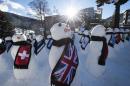 The sun shines over snowmen representing the countries around the world during an exhibition from the NGO "Action2015" on the sideline of the 45th Annual Meeting of the World Economic Forum, WEF, in Davos, Switzerland, Wednesday, Jan. 21, 2015. The meeting runs Jan. 21 through 24 under the overarching theme "The New Global Context". (AP Photo/Keystone, Jean-Christophe Bott)