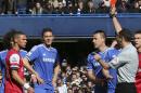 Referee Andre Marriner, in grey, sends off Arsenal's Kieran Gibbs, left, during their English Premier League soccer match between Chelsea and Arsenal at Stamford Bridge stadium in London Saturday, Mar 22 2014. (AP Photo/Alastair Grant)