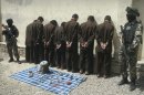 Seven suspected Taliban insurgents are shown to the media in Herat, west of Kabul, Afghanistan, Wednesday, June 20, 2012. Afghan intelligence security forces arrested seven suspected Taliban insurgents on Tuesday with their explosive materials during an operation.(AP Photo/Hoshang Hashimi)