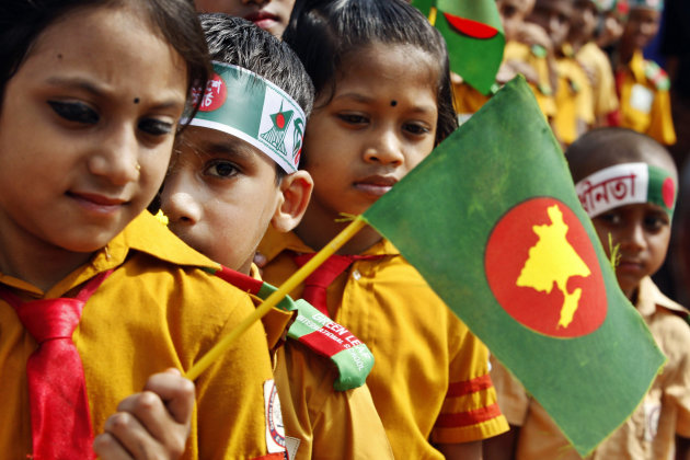 Young Bangladeshi children hold the national flags as they pay tribute to martyrs of the liberation war at the National Memorial during the Independence Day celebrations at Saver on the outskirts of Dhaka, Bangladesh, Monday, March 26, 2012. Bangladesh celebrates its 41st independence day Monday. (AP Photo/Pavel Rahman)