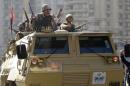 Army soldiers take their positions during clashes with supporters of Muslim Brotherhood and ousted Egyptian President Mohamed Mursi in the Cairo suburb of Matariya