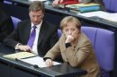 FILE - In this Feb. 26, 2010 file picture German Chanceller Angela Merkel, right, and Vice Chancellor and Foreign Minister Guido Westerwelle listen to a debate about the German Afghanistan mission at the Parliament Bundestag in Berlin, Germany. Germany boasts the world's most powerful woman, Europe's most powerful economy and an industrial machine that's the envy of the world but ahead of Sunday, Sept. 22, election neither incumbent Angela Merkel's conservative forces, nor her center-left rivals _ nor indeed the German people at large _ have any appetite to take center-stage as a European or global leader. (AP Photo/Markus Schreiber,File)