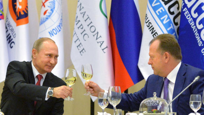 FILE - In this Monday, April 20, 2015 file photo, Russian President Vladimir Putin, left, toasts with Marius Vizer, head of IFJ and SportAccord Convention president, during a reception in Sochi, Russia.  The head of umbrella body SportAccord has issued Thursday May 21 2015 a 20-point plan for discussions with the IOC, including the introduction of prize money for Olympic athletes. Marius Vizer also seeks a 50 percent share for all federations in the IOC's new Olympic television channel, and wants all non-Olympic federations to be allowed to demonstrate their sport before or after each games in the host city.  (Alexei Druzhinin/RIA Novosti, Kremlin Pool Photo via AP, File)