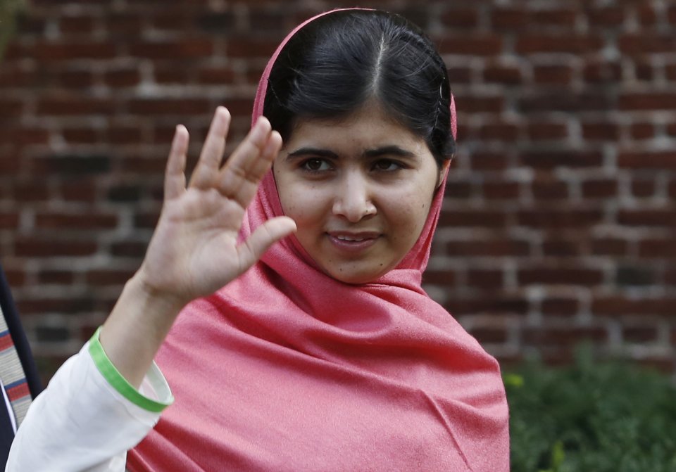 Malala Yousafzai, waves to onlookers after speaking at a news conference on the Harvard University campus in Cambridge, Mass. on Friday, Sept. 27, 2013. The Pakistani teenager, an advocate for education for girls, survived a Taliban assassination attempt in 2012 on her way home from school. (AP Photo/Jessica Rinaldi)