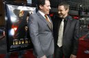 Cast member Robert Downey Jr. smiles at the premiere of film "Iron Man" with its director Jon Favreau at the Grauman Chinese Theatre