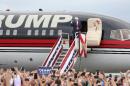Republican presidential nominee Donald Trump pumps his fist to supporters at the conclusion of his campaign event on the tarmac at Lakeland Linder Regional Airport in Lakeland, Florida on October 12, 2016