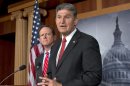 FILE - In this April 10, 2013 file photo, Sen. Joe Manchin, D-W.Va., right, accompanied by Sen. Patrick Toomey, R-Pa., announce that they have reached a bipartisan deal on expanding background checks to more gun buyers,, on Capitol Hill in Washington. The number of Republican senators who might back expanded background checks is now dwindling, threatening a bipartisan effort to subject more gun buyers to the checks. A vote on the compromise, the heart of Congress' gun control effort, is expected this week. (AP Photo/J. Scott Applewhite, File)