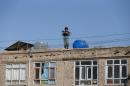An Afghan policeman keeps watch near the site of a suicide attack in Kabul