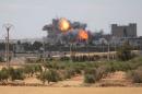 Smoke and flame rise after what fighters of the Syria Democratic Forces (SDF) said were U.S.-led air strikes on the mills of Manbij where Islamic State militants are positioned, in Aleppo Governorate