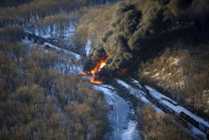 Smoke and flames erupt from the scene of a train derailment …