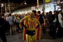A man dressed as a super hero sporting the Catalan independence standard and a mask celebrates after the partial results of the regional election in Barcelona, Spain, September 27, 2015