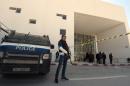 Tunisian security forces and forensic experts stand at the visitors entrance of the National Bardo Museum in Tunis on March 19, 2015, in the aftermath of an attack