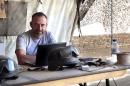In this photo released by Spanish newspaper El Periodico de Catalunya on Sunday March 2, 2014, journalist Marc Marginedas who works for the newspaper, sits by his laptop at the Canadian base in Nakhonay, Afganistan in this photo taken on Oct. 10, 2010. Marginedas, who was kidnapped by al-Qaida-linked militants in Syria crossed the border into Turkey on Sunday March 2, 2014 his newspaper reported, as activists said government airstrikes killed at least 13 people in a northwestern border town. Veteran war correspondent Marc Marginedas was abducted on Sept. 4 near Hama by jihadists belonging to the Islamic State of Iraq and the Levant, a breakaway al-Qaida group. He was "moved repeatedly" while in captivity and was accused of spying for the West before his release, his newspaper El Periodico said. (AP Photo/Agustin Catalan, El Periodico de Catalunya)