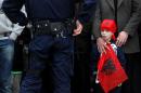 A child holding an Albanian flag awaits the arrival of the prime minister prior to his visit to the town of Presevo on November 11, 2014