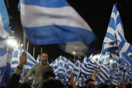 <p>               A member of New democracy party shouts slogans during Greece's conservative leader of New Democracy Antonis Samaras speech at the Zappeio conference hall in Athens, Thursday, May 3, 2012. Samaras who joined the majority Socialists in a coalition for the past six months, is leading in opinion polls but is facing a strong challenge from rightist splinter parties and a fascist party that have campaigned heavily on illegal immigration in the crisis-hit country. (AP Photo/Thanassis Stavrakis)