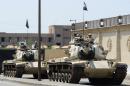 Egyptian military tanks are positioned outside the police institute, Cairo, on April 10, 2014