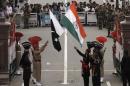 Pakistani rangers and Indian Border Security Force officers lower their national flags during a daily parade at the Pakistan-India joint check-post at Wagah
