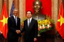 U.S. President Barack Obama shakes hands with Vietnam's President Tran Dai Quang after an arrival ceremony at the presidential palace in Hanoi, Vietnam