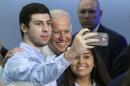 Vice President Joe Biden poses for a selfie with supporters Wednesday, Sept. 2, 2015, at Miami Dade College in Miami. Vice President Biden traveled to Florida to support Senate Democrats and the administration's education agenda. (AP Photo/Alan Diaz)