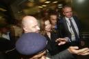 Valerie Trierweiler, center, former partner of French President Francois Hollande, is escorted by security after she arrived at the Chhatrapati Shivaji International Airport in Mumbai, India, Monday, Jan 27, 2014. Trierweiler is on a two-day visit to India.(AP Photo/Rafiq Maqbool)