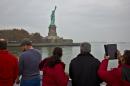 FILE - In this Nov. 5, 2015, file photo, visitors view the Statue of Liberty during a ferry ride to Liberty Island in New York. The travel industry is debating whether President Donald Trump's ban on travel from seven countries will have a larger impact on tourism in the U.S. Some experts say the controversy will have no effect while others worry that it sends an unwelcoming message to travelers around the world. An op-ed piece in the Toronto Star on Jan. 30, 2017, encouraged Canadians to boycott the U.S. for now, saying that the Statue of Liberty will still be there in a few years. (AP Photo/Bebeto Matthews, File)