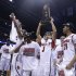 Louisville guard Peyton Siva (3) holds up the regional trophy as Louisville players celebrate their 85-63 win over Duke in  the Midwest Regional final in the NCAA college basketball tournament, Sunday, March 31, 2013, in Indianapolis. (AP Photo/Michael Conroy)