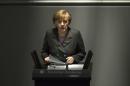 German Chancellor Angela Merkel delivers her speech, on the Ukrainian crisis at the parliament Bundestag in Berlin, Thursday, March 13, 2014, German Chancellor Angela Merkel warned Moscow on Thursday that if it continues its current course in the Ukraine crisis, Russia risks 