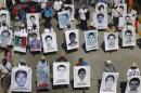 Relatives hold pictures of missing students from the Ayotzinapa Teacher Training College Raul Isidro Burgos, during a demonstration demanding the government find them, in Chilpancingo, Guerrero