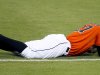 Miami Marlins' Giancarlo Stanton holds his head after being injured in the 10th inning of a baseball game against the New York Mets at Marlins Park in Miami on Monday, April 29, 2013. (AP Photo/The Miami Herald, Joe Rimkus Jr.)