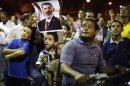 A supporter of deposed Egyptian President Mursi and sons sit on motorbike as they listen to speech during sit-in protest in Cairo