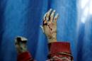 Blood covers the hands of an injured boy lying in a field hospital after what activists said were air strikes by forces loyal to Syria's President Bashar al-Assad in the Douma neighbourhood of Damascus