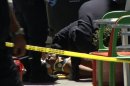 In this frame grab from video, emergency personnel tend to an injured man after a shooting outside a shopping center in San Francisco, Friday July 12, 2013. Two women were killed and a man was wounded on Friday before a suspect covered in blood was arrested at a shopping center in a crowded neighborhood that is home to police headquarters and several tech companies, authorities said. Investigators were trying to determine if the shooting was connected to a botched robbery. (AP Photo/Haven Daley)