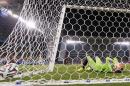 Russia's goalkeeper Igor Akinfeev covers his face after dropping the ball as South Korea's Lee Keun-ho scores the opening goal during the group H World Cup soccer match between Russia and South Korea at the Arena Pantanal in Cuiaba, Brazil, Tuesday, June 17, 2014. (AP Photo/Lee Jin-Man)