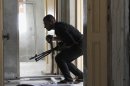 A Free Syrian Army fighter takes cover in Ashrafieh, Aleppo