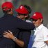 U.S. captain Love III congratulates Watson and Simpson after they defeated Team Europe golfers Hanson and Lawrie on the 14th green during the afternoon four-ball round at the 39th Ryder Cup matches at the Medinah Country Club