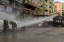 Turkish riot police use a water cannon to disperse Kurdish demonstrators during a protest against a curfew in Sur district and security operations in the region, in Diyarbakir, Turkey