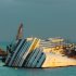 The cruise ship Costa Concordia, leaning on its side, is seen just off the coast of the Tuscan island of Giglio, Italy, Saturday, Jan. 12, 2013. As if the nightmares, flashbacks and anxiety weren't enough, passengers who survived the terrifying grounding and capsizing of the Costa Concordia off Tuscany have come in for a rude shock as they mark the first anniversary of the disaster on Sunday. Ship owner Costa Crociere SpA, the Italian unit of Miami-based Carnival Corp., sent several passengers a letter telling them they weren't welcome at the official anniversary ceremonies on the island of Giglio where the hulking ship still rests. Costa says the day is focused on the families of the 32 people who died Jan. 13, 2012, not the 4,200 passengers and crew who survived. (AP Photo/Paolo Santalucia)