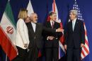 From left, EU High Representative for Foreign Affairs and Security Policy, Federica Mogherini, Iranian Foreign Minister, Mohammad Javad Zarif, British Foreign Secretary, Philip Hammond, and U.S. Secretary of State, John Kerry, line up for a press announcement after the end of a new round of Nuclear Iran Talks in the Learning Center at the Swiss federal Institute of Technology (EPFL), in Lausanne, Switzerland, Thursday, April 2, 2015. (AP Photo/Keystone, Jean-Christophe Bott)