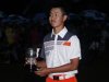Guan Tianlang of China holds the trophy he was awarded for low amateur following the 2013 Masters golf tournament in Augusta