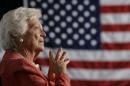 Former U.S. first lady Barbara Bush listens to her son President George W. Bush at an event in Orlando.