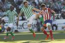 Atletico de Madrid's Diego Costa, right, and Betis' Jordi Figueras , centre, fight for the ball as Betis' Paulao Santos, right, looks on during their La Liga soccer match at the Benito Villamarin stadium, in Seville, Spain on Sunday, March 23, 2014. (AP Photo/Angel Fernandez)