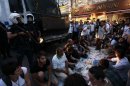 Anti-government protesters eat as they break their fast on the first day of the holy month of Ramadan
