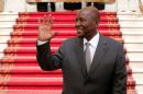 Ivory Coast Prime Minister Daniel Kablan Duncan waves after the resignation of his government in the Presidential Palace in Abidjan