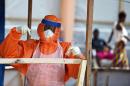 A health worker wearing personal protective equipment works on November 11, 2014 in the red zone of the Hastings treatment center outside Freetown