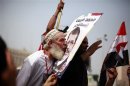 A supporter of the Muslim Brotherhood's presidential candidate Mohamed Morsy kisses a picture of him during a celebration at Tahrir square in Cairo