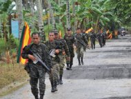 This file photo shows Moro Islamic Liberation Front (MILF) rebels patrolling inside their base at Camp Darapan, Sultan Kudarat province, on the southern Philippine island of Mindanao, in 2011. Indonesian peace monitors on Sunday joined an international mission tasked to ensure that a ceasefire between the Philippines and Muslim insurgents held as both sides aim to sign a peace deal this year