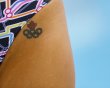 A Canadian swimmer sports an Olympic rings tattoo at the Aquatics Centre before the start of the London 2012 Olympic Games in London