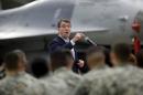 U.S. Defense Secretary Ash Carter addresses U.S. military personnel during a meeting near an F-16 fighter jet at Osan U.S. Air Base in Pyeongtaek